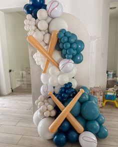 a bunch of balloons and baseballs are stacked on top of each other in a room