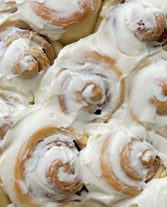 a close up view of cinnamon rolls with icing