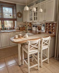 a kitchen with a table and chairs in it