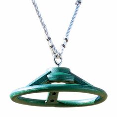 a green necklace with an object hanging from it's center