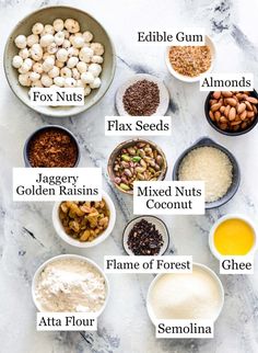 an image of different types of nuts in bowls on a marble counter top with labels