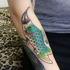 a woman with a fish tattoo on her arm