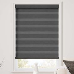 a grey roller shade in a living room