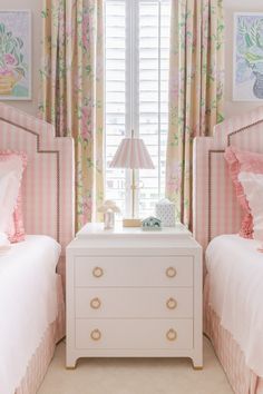 two twin beds in a bedroom with pink and white bedding