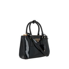 The Galleria Mini Patent Leather Handbag by PRADA is a galleria mini patent leather handbag crafted to the highest standards, offering both style and functionality. Prada Mini, Patent Leather Handbags, Makeup Travel Case, Travel Makeup, Black Mini, Beauty Accessories, Travel Case, Handbags On Sale, Evening Wear