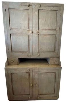 an old wooden cabinet with two doors on the front and one door open to reveal a shelf