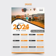 an orange and white calendar with hot air balloons in the sky, on a gray background