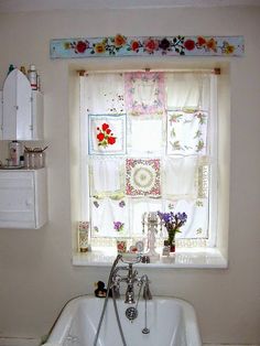 a bath tub sitting under a window next to a sink