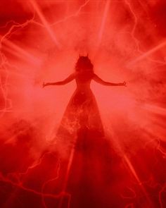 a woman standing in the middle of a red light with her arms outstretched and hands out