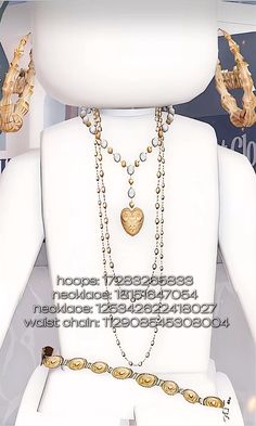 a white mannequin with gold jewelry on it