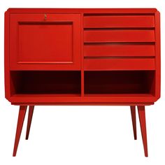 a red cabinet with two drawers on one side and an open drawer on the other