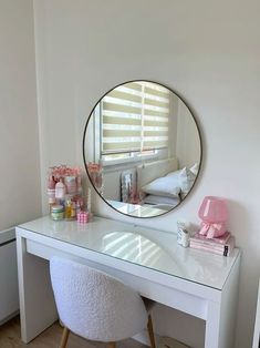 a white desk with a mirror and stool