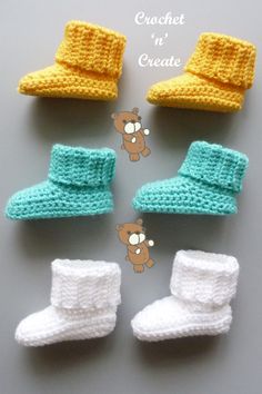 four crocheted baby booties are arranged in the shape of a teddy bear