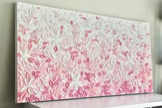 a pink and white painting on a wall