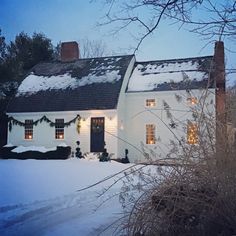 a white house with christmas lights on the windows