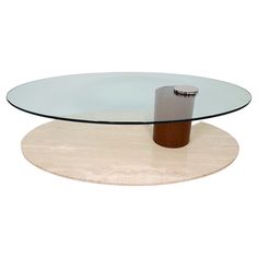 an oval glass table with a wooden base and metal object in the middle, on a white background