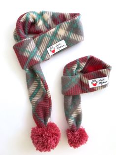 Red and Gray Plaid Dog & Cat Scarf   Love, Matisse fleece scarves for dogs and cats are made from an original scarf design. Each scarf is adorned with a playful yarn pom making this scarf a standout accessory!  Our pet scarves easily slip over your cat or dog's head and can be tightened or loosened by pulling on the pom end.  The scarves are  made from a durable and soft fleece fabric.  Get a matching scarf for yourself! Human scarves have two large pom poms on the ends of the scarf. Sizing  Mea Dog Scarf Pattern, Matisse Dog, Fleece Scarves, Large Pom Poms, Puppy Scarf, Bichon Havanais, Cat Scarf, Holiday Dog, Fleece Scarf