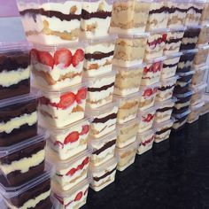 many desserts are arranged in plastic containers on the counter, ready to be eaten