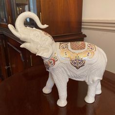 an elephant figurine sitting on top of a wooden table