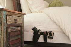 a camera is laying on the bed next to it's headboard and foot board