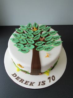 a white cake with a tree on top that says derek is 10 and has green leaves