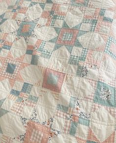 a bed with a quilt on top of it