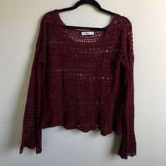 a red sweater hanging on a white wall