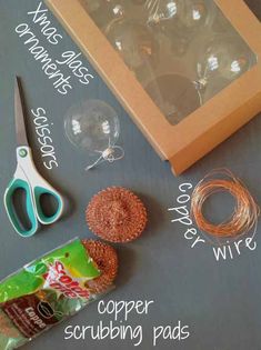 a chalk board with scissors, wire, and other items to make a christmas ornament