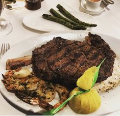 steak, shrimp and asparagus on a white plate