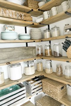 the shelves are filled with many different types of dishes and containers, including jars, bowls, and spoons