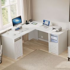 a white desk with a computer on top of it in front of a large window