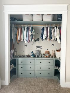 an organized closet with clothes hanging on the wall and stuffed animals sitting on the dressers