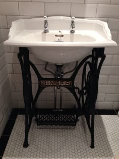 an old fashioned sewing machine sink in a bathroom