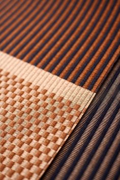 a close up view of a brown and blue striped tie on a piece of cloth