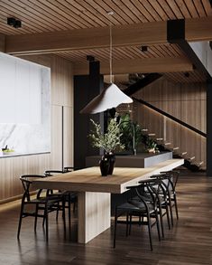 a dining room table with chairs and a lamp hanging from it's center beam