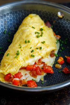 an omelet with tomatoes and cheese in a bowl