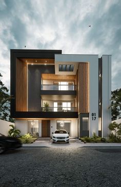 a white car is parked in front of a modern building with wooden and glass balconies