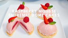 raspberry mousse entret dome cakes on a white plate