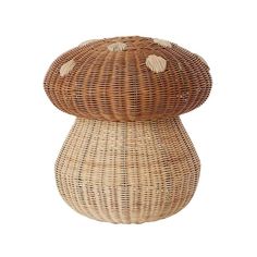 a wicker mushroom shaped stool with shells on it's top and bottom, in front of a white background