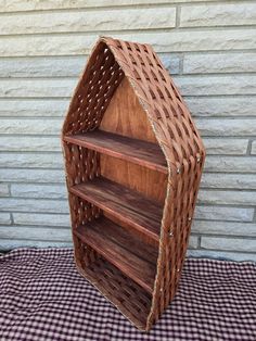 a wooden shelf sitting on top of a checkered table cloth