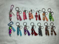 a collection of key chains with tassels and beads