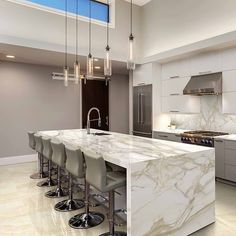 a kitchen with marble counter tops and bar stools