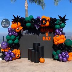 an arch made out of balloons and halloween decorations