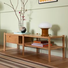 a table with some books and a vase on it