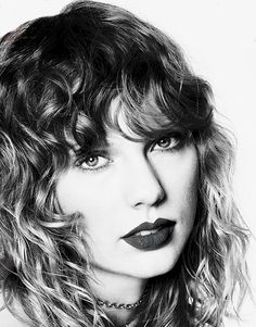 a black and white photo of a woman with wavy hair wearing a choker necklace