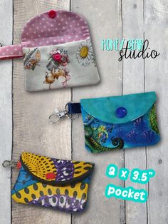 three small purses with different designs on them