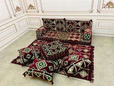 a group of red and green rugs sitting on top of a floor