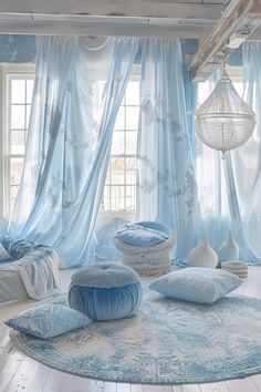 a room with blue curtains and pillows on the floor in front of a round rug