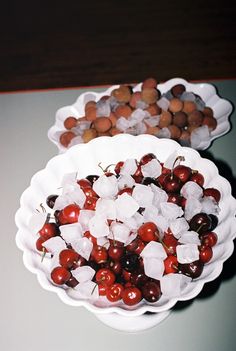 two bowls filled with cherries and ice cubes