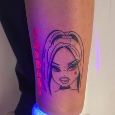 a woman's leg with a black and purple tattoo design on her left calf